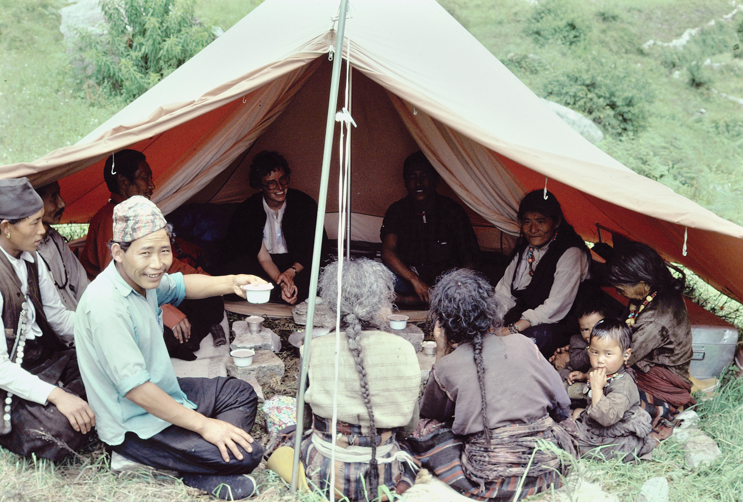 Hanna Rauber mit einer Gemeinschaft von Bhote Khampa beim Biertrinken in einem Zelt.